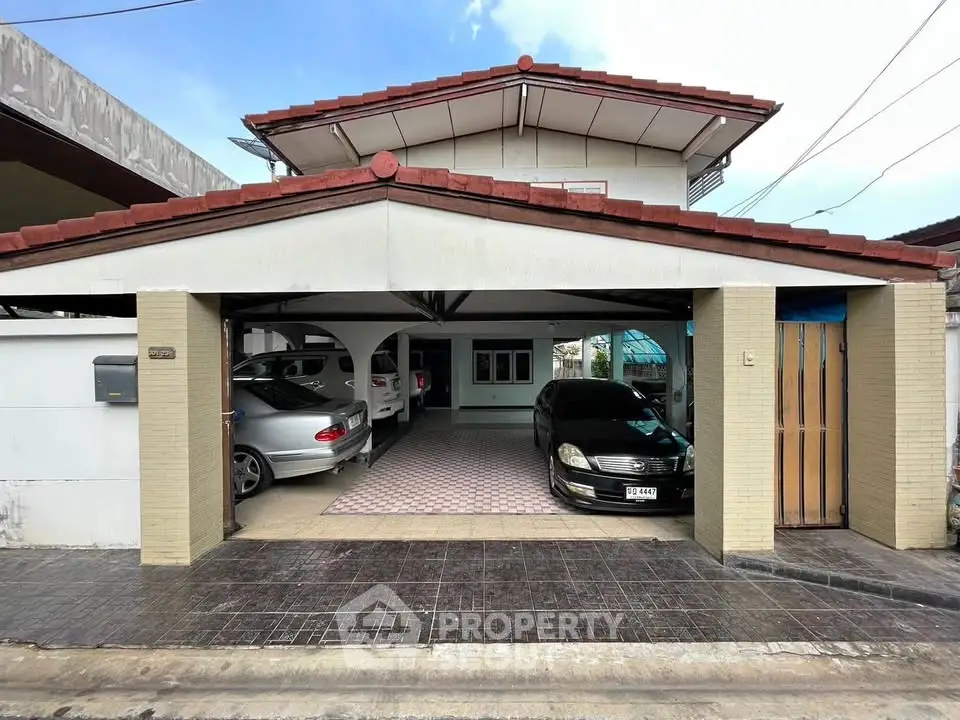 Charming suburban house with spacious carport and tiled driveway, perfect for family living.