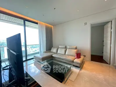 Luxurious living room with modern leather sofa and stunning city view from large windows.