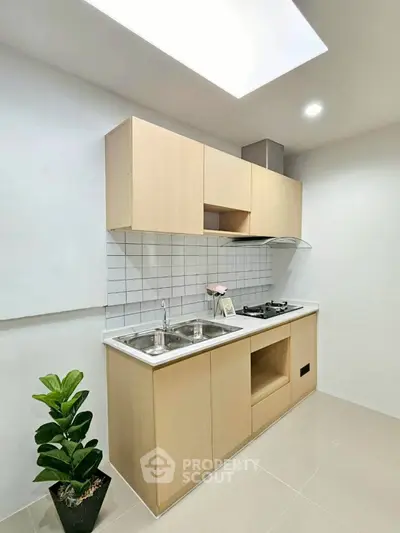Modern kitchen with sleek cabinetry and gas stove, perfect for culinary enthusiasts.