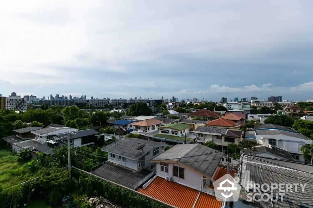 Scenic aerial view of suburban neighborhood with diverse rooftops and lush greenery.