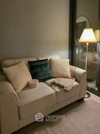 Cozy living room with elegant sofa and soft lighting, perfect for relaxation and comfort.
