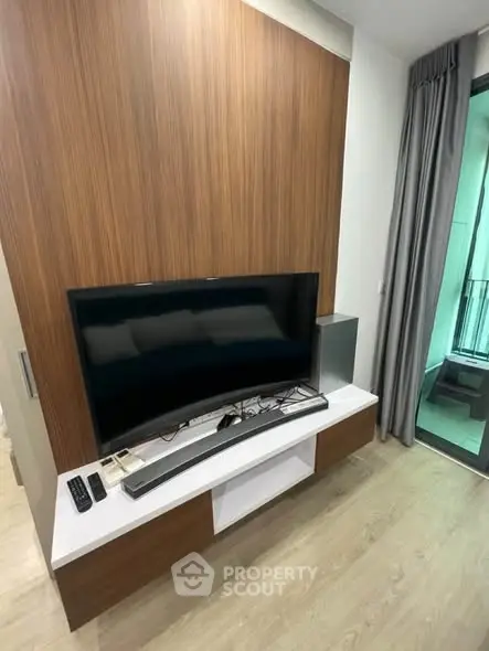 Modern living room with sleek TV setup and stylish wooden paneling