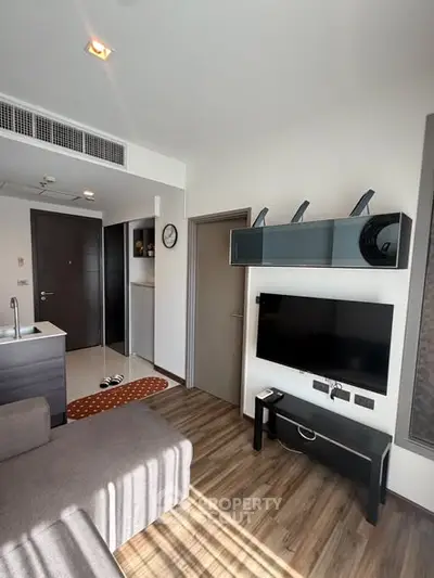 Modern living room with sleek design, featuring a wall-mounted TV and stylish shelving, perfect for urban living.