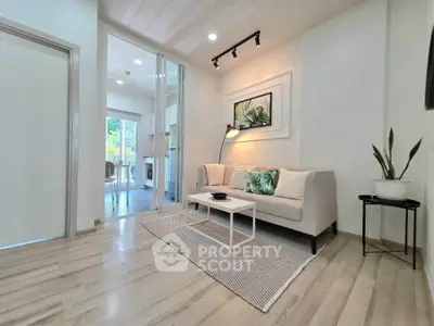 Modern living room with sleek design and natural light, featuring a cozy sofa and stylish decor.
