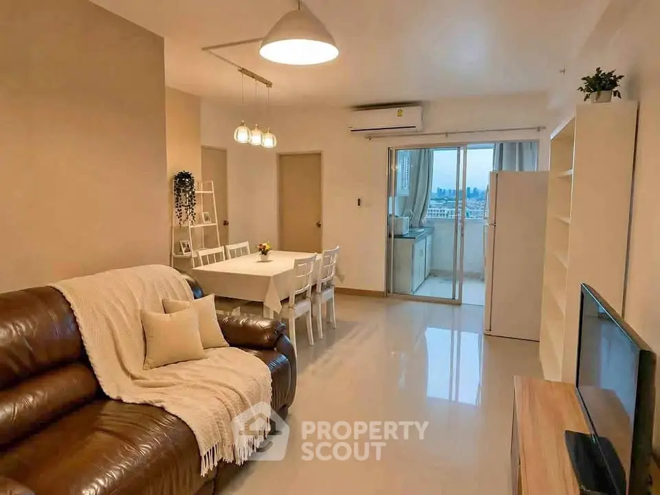 Spacious modern living room with dining area and balcony view