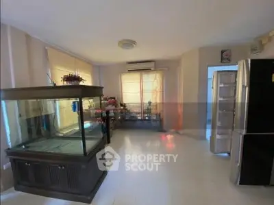 Spacious room with large aquarium and modern appliances