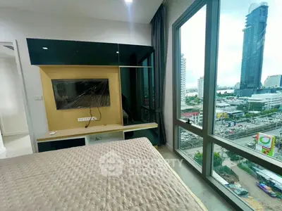 Modern bedroom with large windows offering stunning city views in a high-rise building.