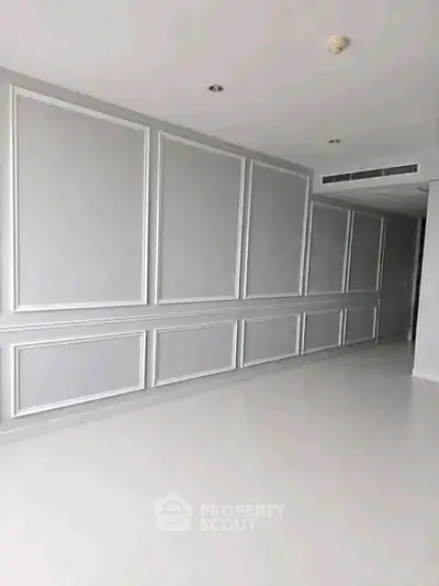 Spacious modern interior with elegant wall paneling and sleek flooring, perfect for customization.