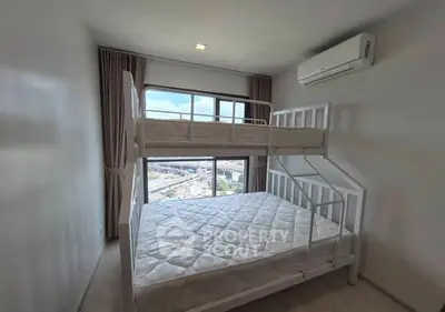 Modern bedroom with bunk bed and city view, featuring air conditioning and large window.