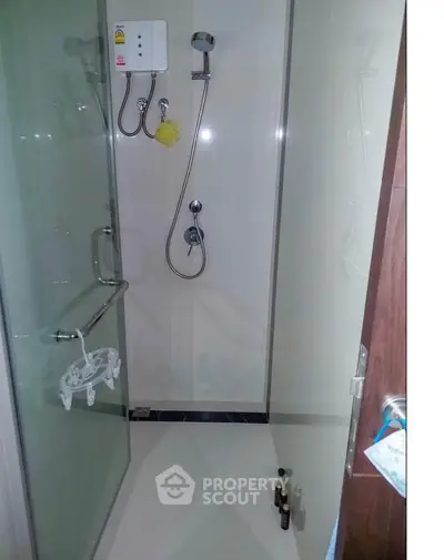 Compact bathroom with glass shower enclosure and modern fixtures