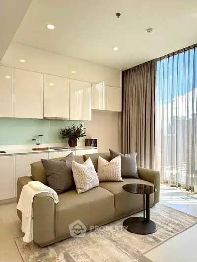 Modern living room with stylish sofa and open kitchen layout, featuring floor-to-ceiling windows and elegant decor.