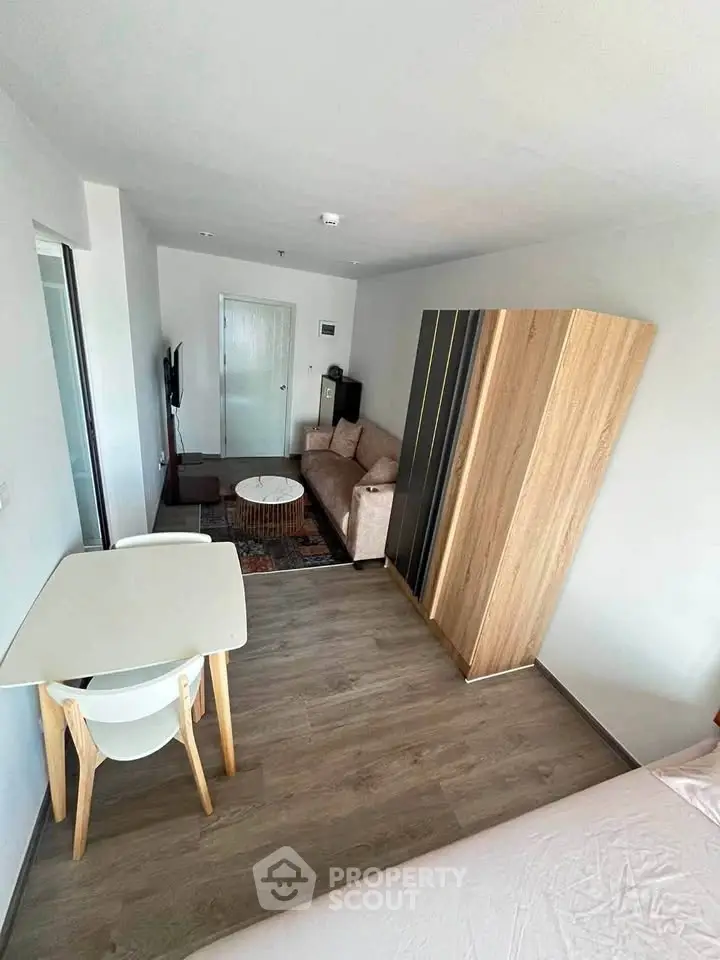 Modern studio apartment with stylish furniture and open layout, featuring a cozy living area and dining space.