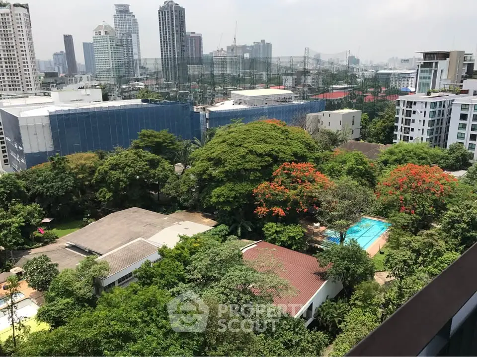 Stunning cityscape view with lush greenery and pool, ideal for urban living.