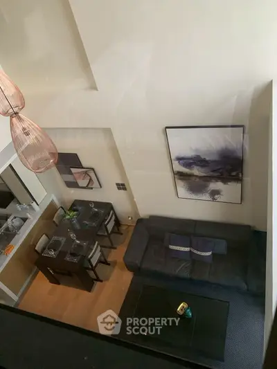 Modern loft-style living room with high ceiling and stylish decor