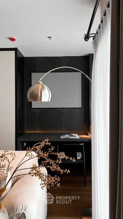 Modern living room with sleek decor and stylish lighting, featuring a cozy reading nook by the window.