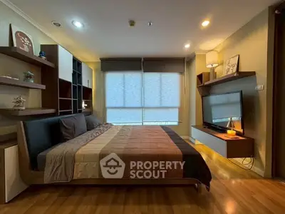 Modern bedroom with stylish decor and large window for natural light