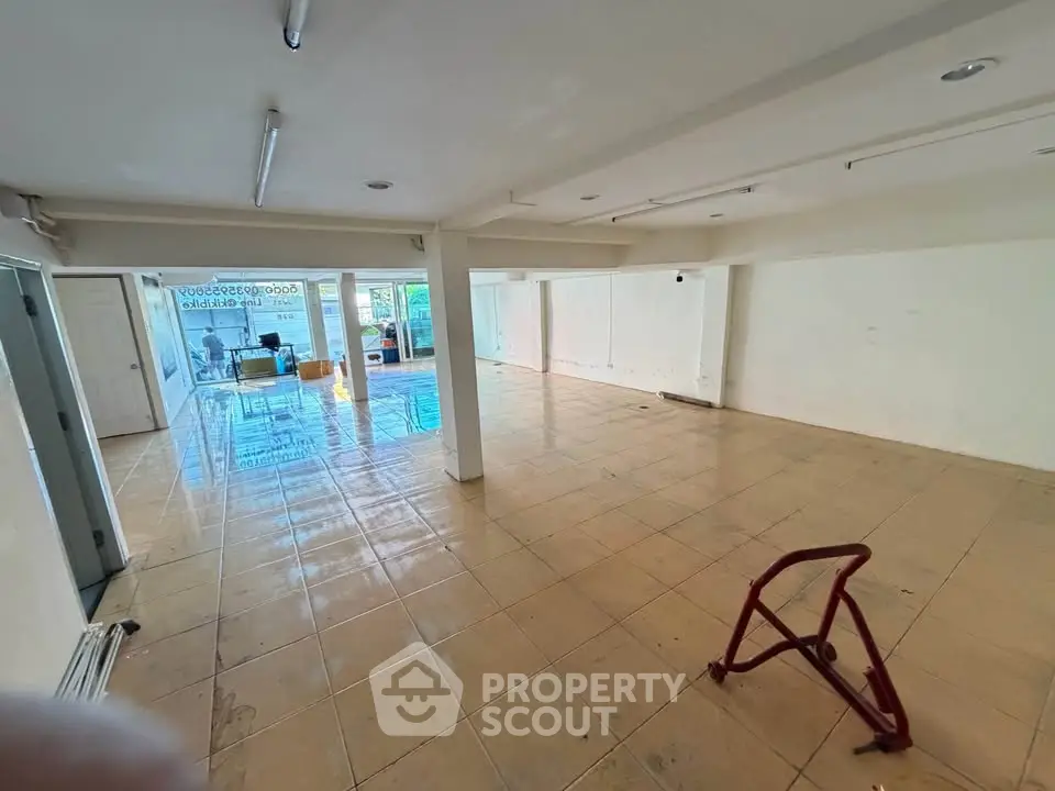Spacious commercial space with tiled flooring and ample natural light, ideal for business setup.