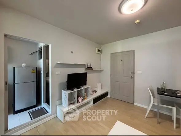 Modern living room with sleek furniture and open kitchen layout in a stylish apartment.