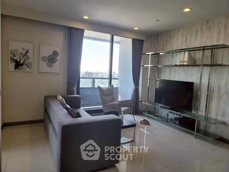 Modern living room with large window and stylish decor in high-rise apartment.