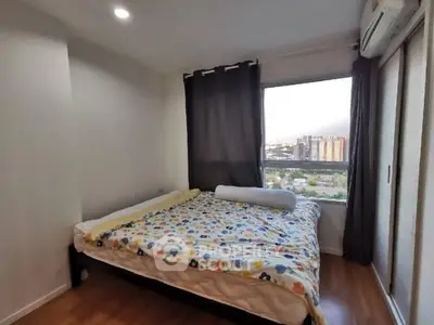 Cozy bedroom with city view and floral bedding in modern apartment