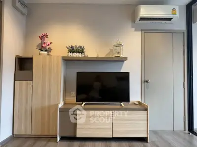 Modern living room with sleek TV stand and air conditioning unit.