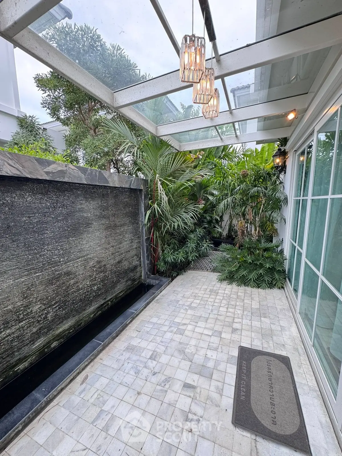 Elegant garden patio with water feature and lush greenery