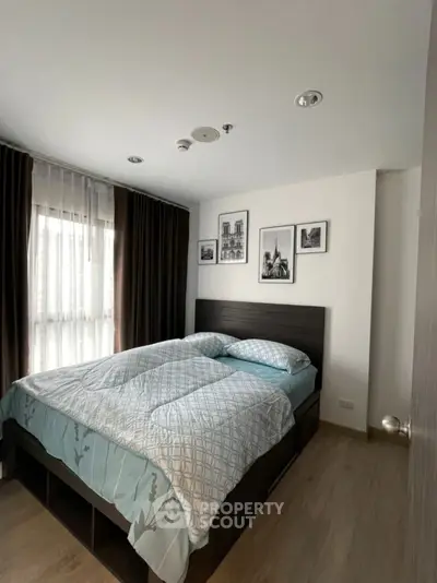 Cozy bedroom with modern decor and large window for natural light