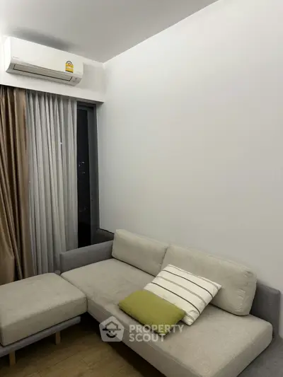 Modern living room with sleek sofa and air conditioning, perfect for urban living.