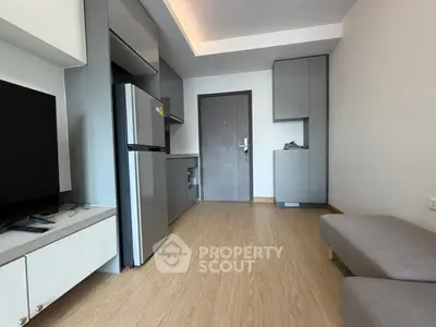 Modern studio apartment with sleek kitchen and cozy living area