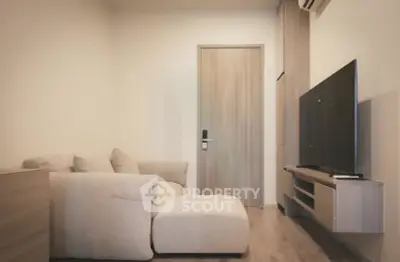 Modern living room with cozy beige sofa and sleek TV setup, perfect for relaxation.
