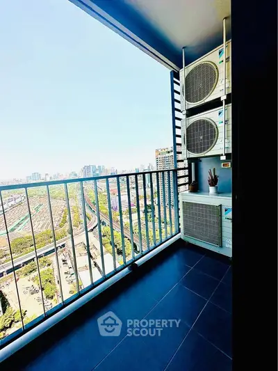 Spacious balcony with stunning city view and modern air conditioning units.
