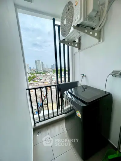 High-rise apartment balcony with washing machine and city view