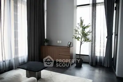 Modern living room with stylish decor and large windows