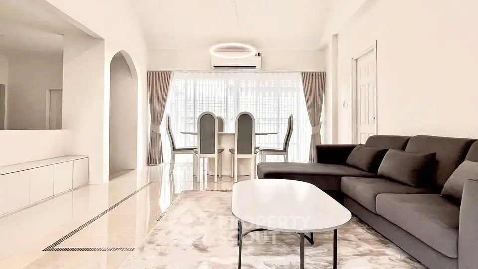 Spacious modern living room with elegant dining area and stylish furniture