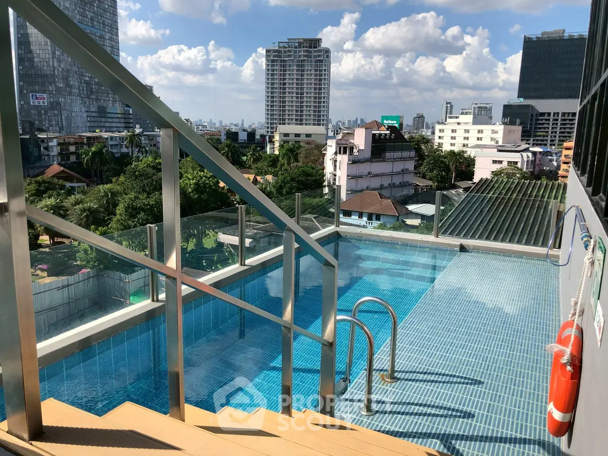 Stunning rooftop pool with city skyline views, perfect for relaxation and leisure.