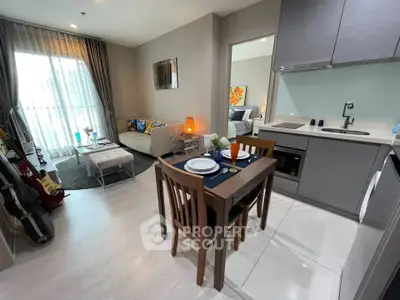 Modern open-plan living room and kitchen with stylish decor and natural light.