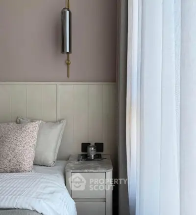 Cozy bedroom with elegant lighting and plush bedding, perfect for relaxation.