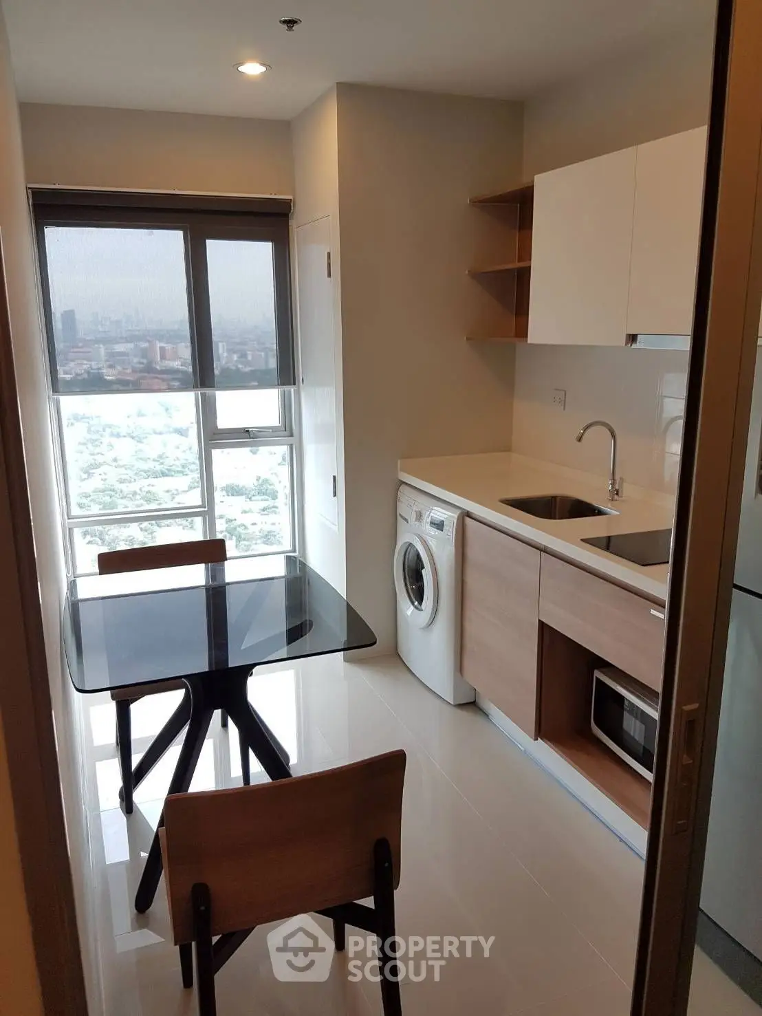 Modern living room with large window offering stunning city view