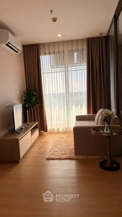 Modern living room with natural light, sleek furniture, and elegant decor in a stylish apartment.