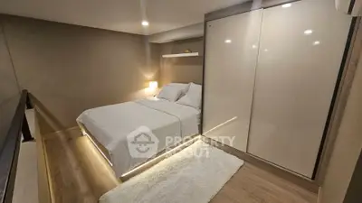 Modern bedroom with sleek design, featuring a cozy bed and stylish wardrobe in a contemporary apartment.