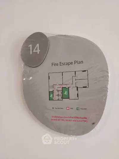 Modern fire escape plan sign on wall in residential building