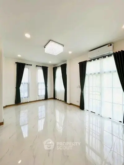 Spacious and bright living room with elegant curtains and modern lighting