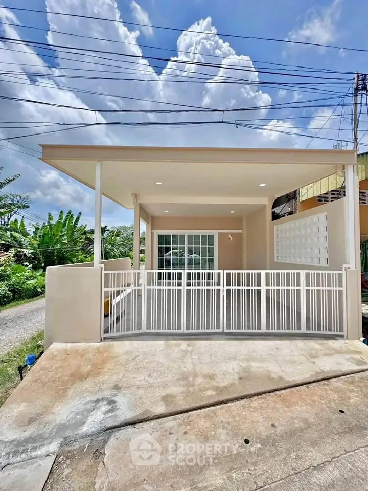 Charming single-story home with modern facade and spacious driveway, perfect for family living.