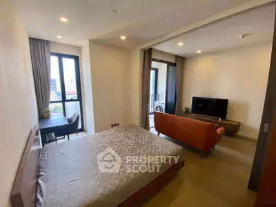 Modern studio apartment with city view, featuring cozy living area and stylish bedroom.