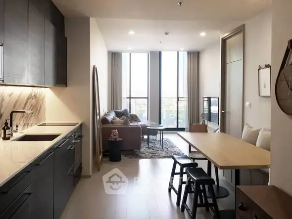 Modern open-plan living room with sleek kitchen and cozy seating area