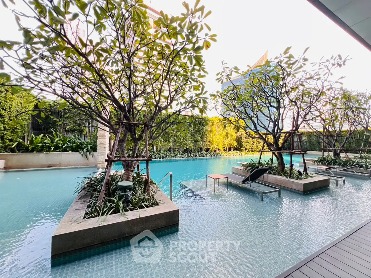 Luxurious outdoor pool with lush greenery and modern design, perfect for relaxation and leisure.