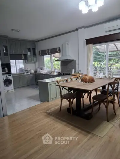 Spacious kitchen with dining area and modern appliances in a bright, open layout.