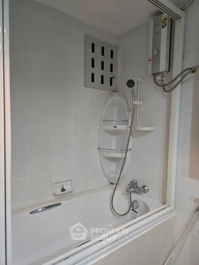 Modern bathroom with bathtub and shower in sleek white tile design.