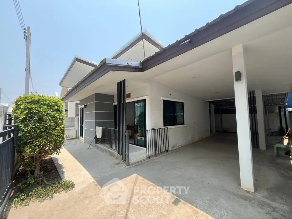 Charming single-story home with spacious driveway and modern exterior design.