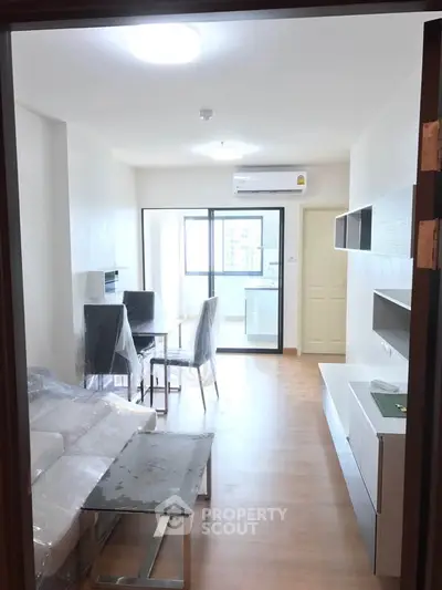 Modern living room with sleek furniture and natural light in a contemporary apartment.